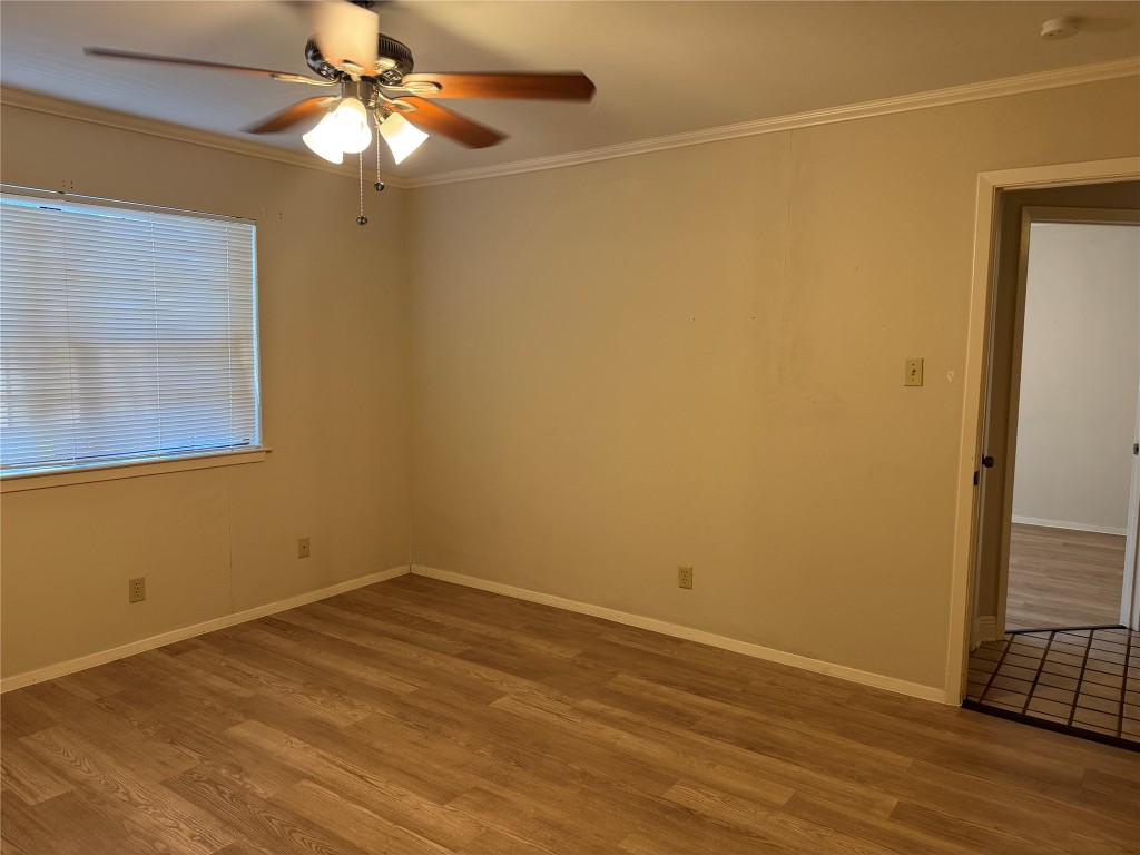 2907 Pearl Street, Unit 103 Austin, TX 78705 - Photo 14 of 20 an empty room with wooden floor and fan