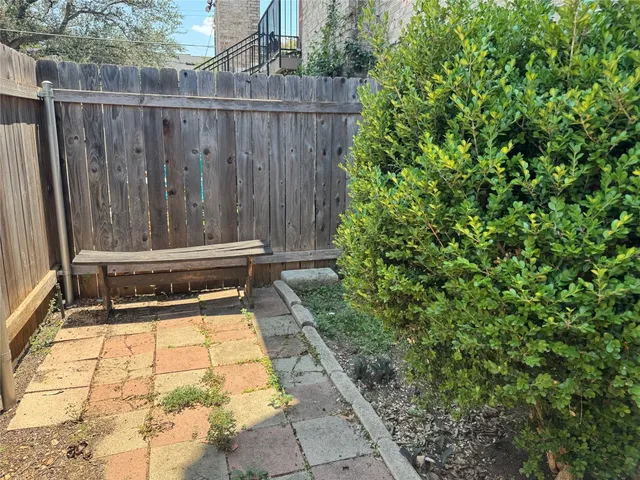 a view of deck with wooden fence and trees