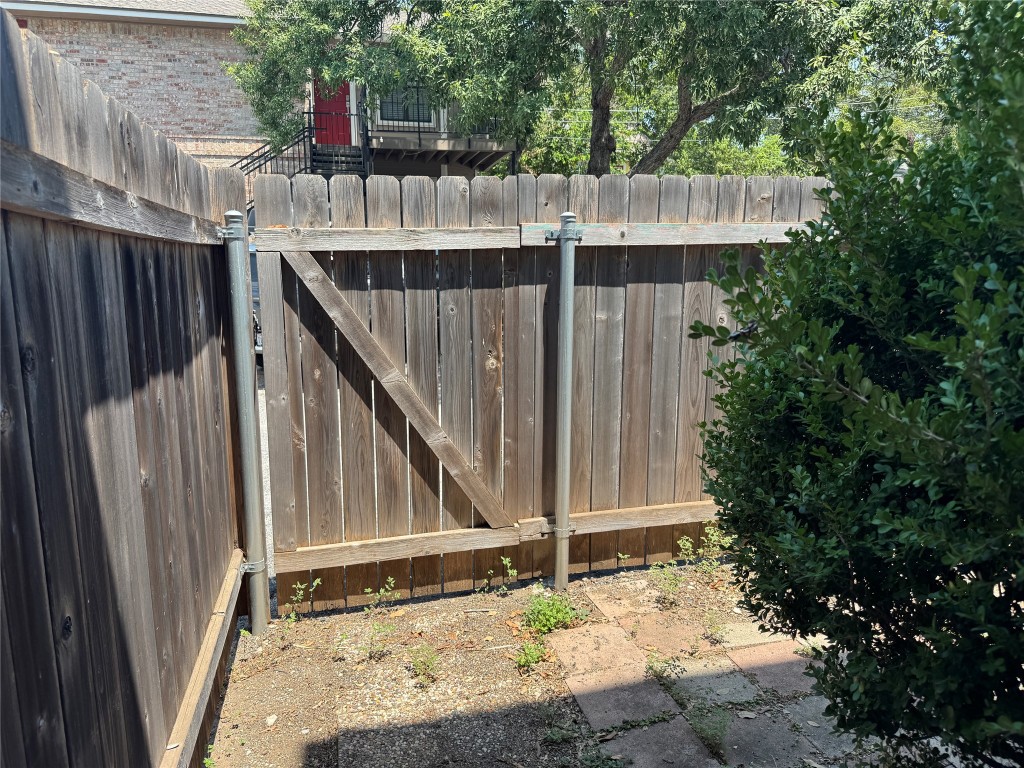 2907 Pearl Street, Unit 103 Austin, TX 78705 - Photo 18 of 20 a view of deck with wooden fence and trees