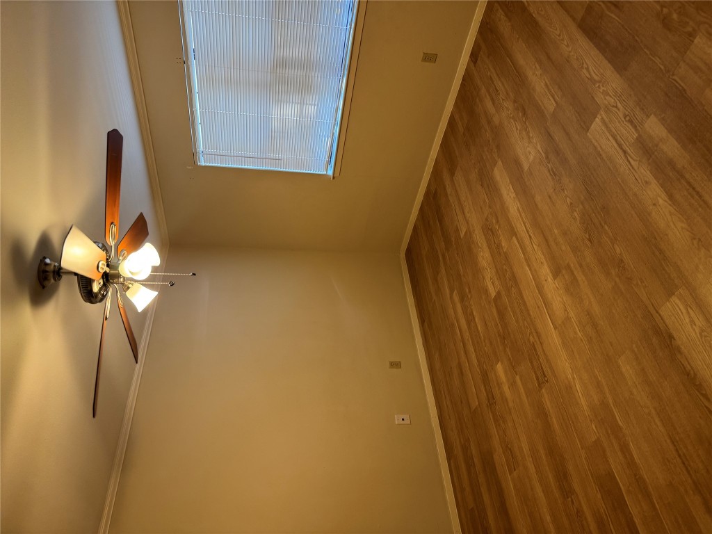 2907 Pearl Street, Unit 103 Austin, TX 78705 - Photo 10 of 20 a view of a room with a ceiling fan and wooden floor