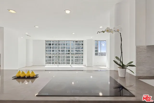 a view of a kitchen with a refrigerator and a sink