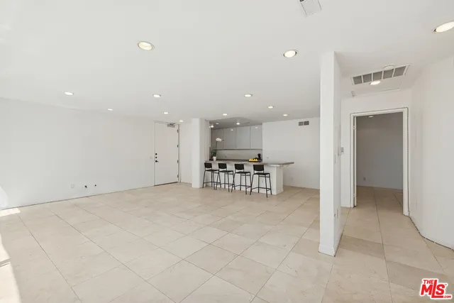 a view of kitchen with furniture and refrigerator