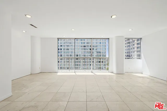 a view of a kitchen with a sink and chairs