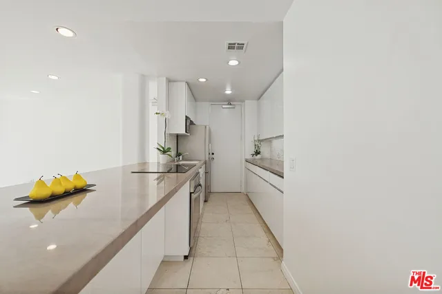 a kitchen with stainless steel appliances granite countertop a sink stove and a refrigerator
