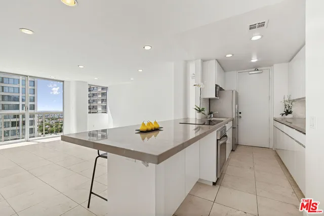 a kitchen with a sink appliances and cabinets