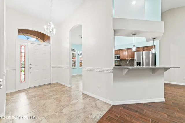 a kitchen with stainless steel appliances granite countertop a stove a sink dishwasher and a refrigerator