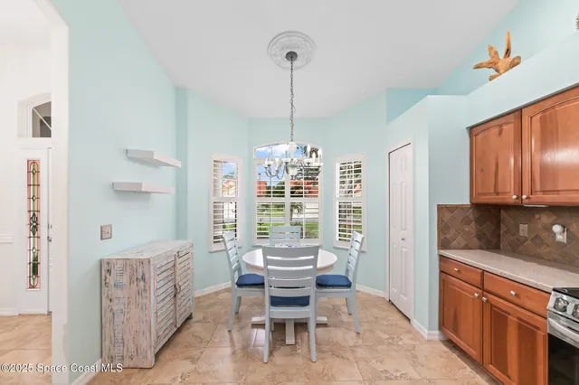 a view of a livingroom with furniture wooden floor and a ceiling fan