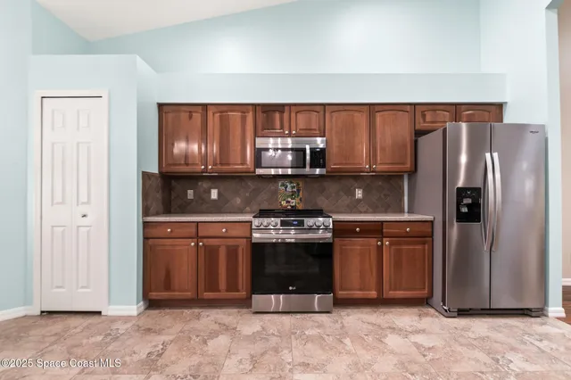 a view of a room with wooden floor and a ceiling fan