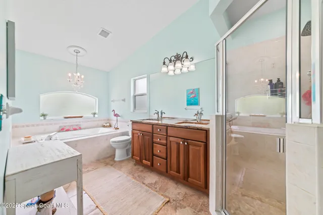 a bathroom with a granite countertop bathtub a sink and a mirror