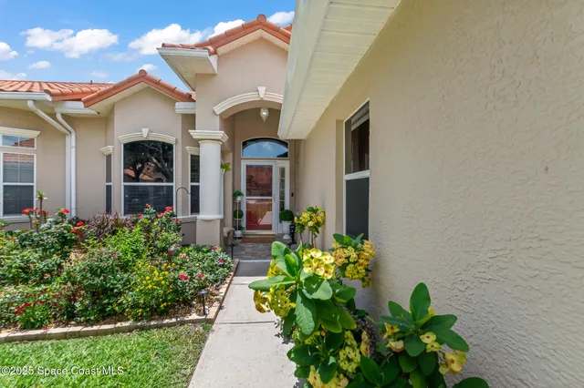 a front view of a house with a lot of flower pots