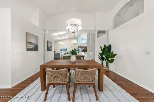 a dining room with furniture and wooden floor