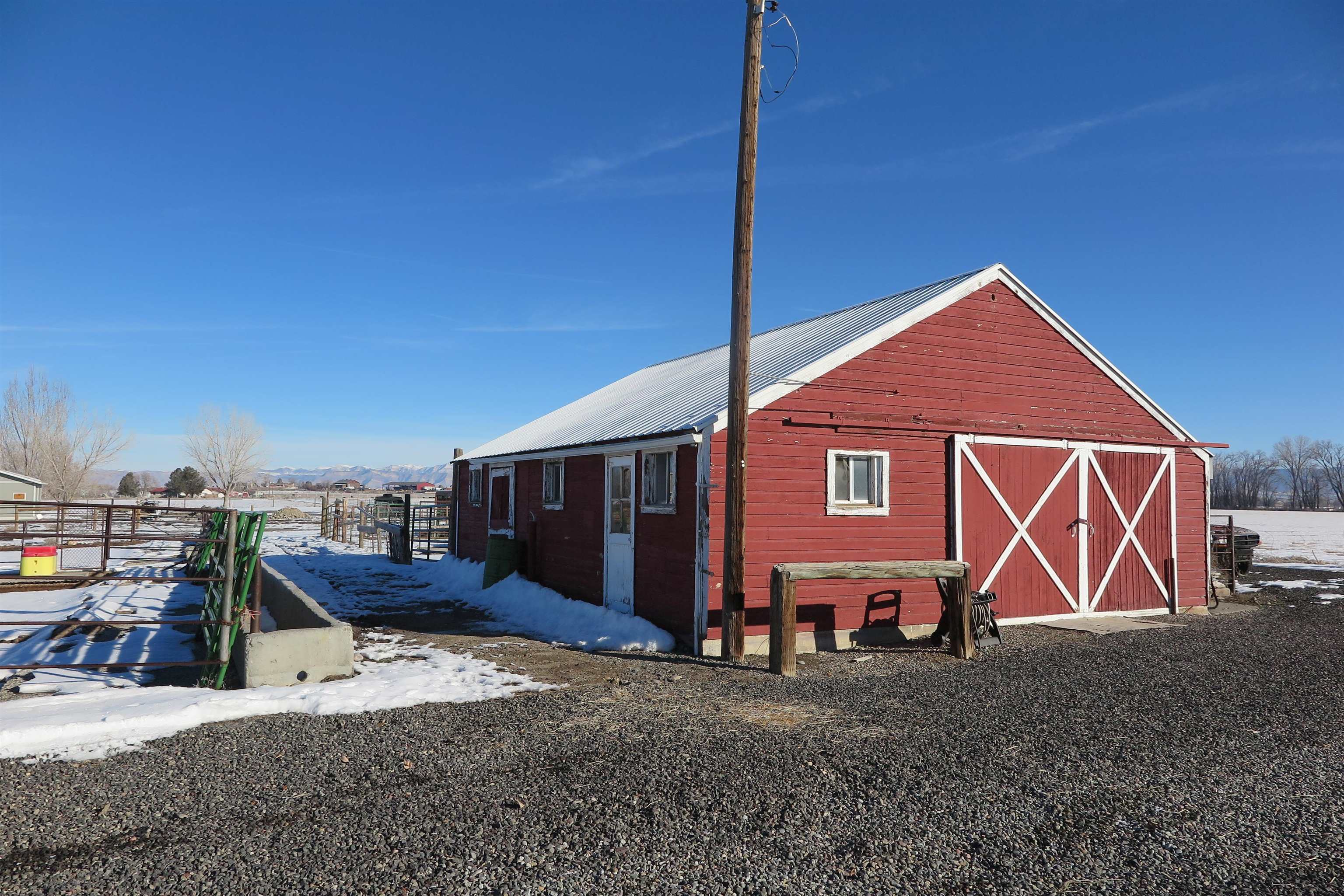 2050 J Road Fruita, CO 81521 - Photo 2 of 2 a backyard of a house with barbeque oven table and chairs
