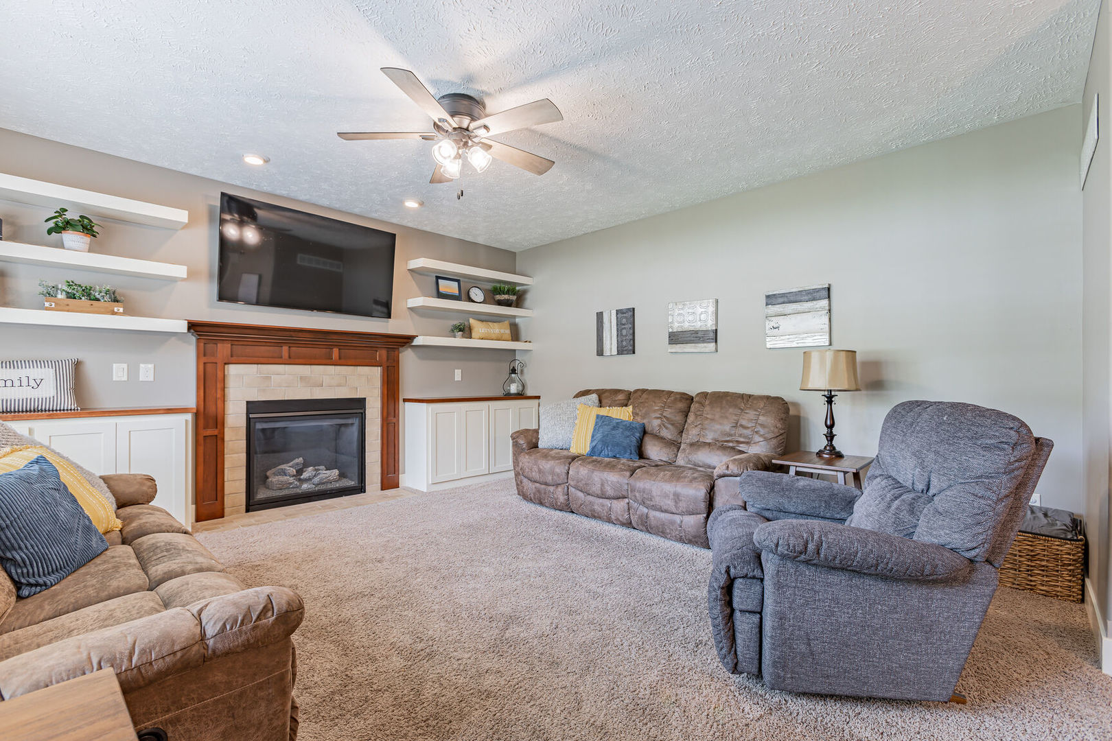 5 Fletcher Court Savoy, IL 61874 - Photo 11 of 48 a living room with furniture a fireplace and a flat screen tv