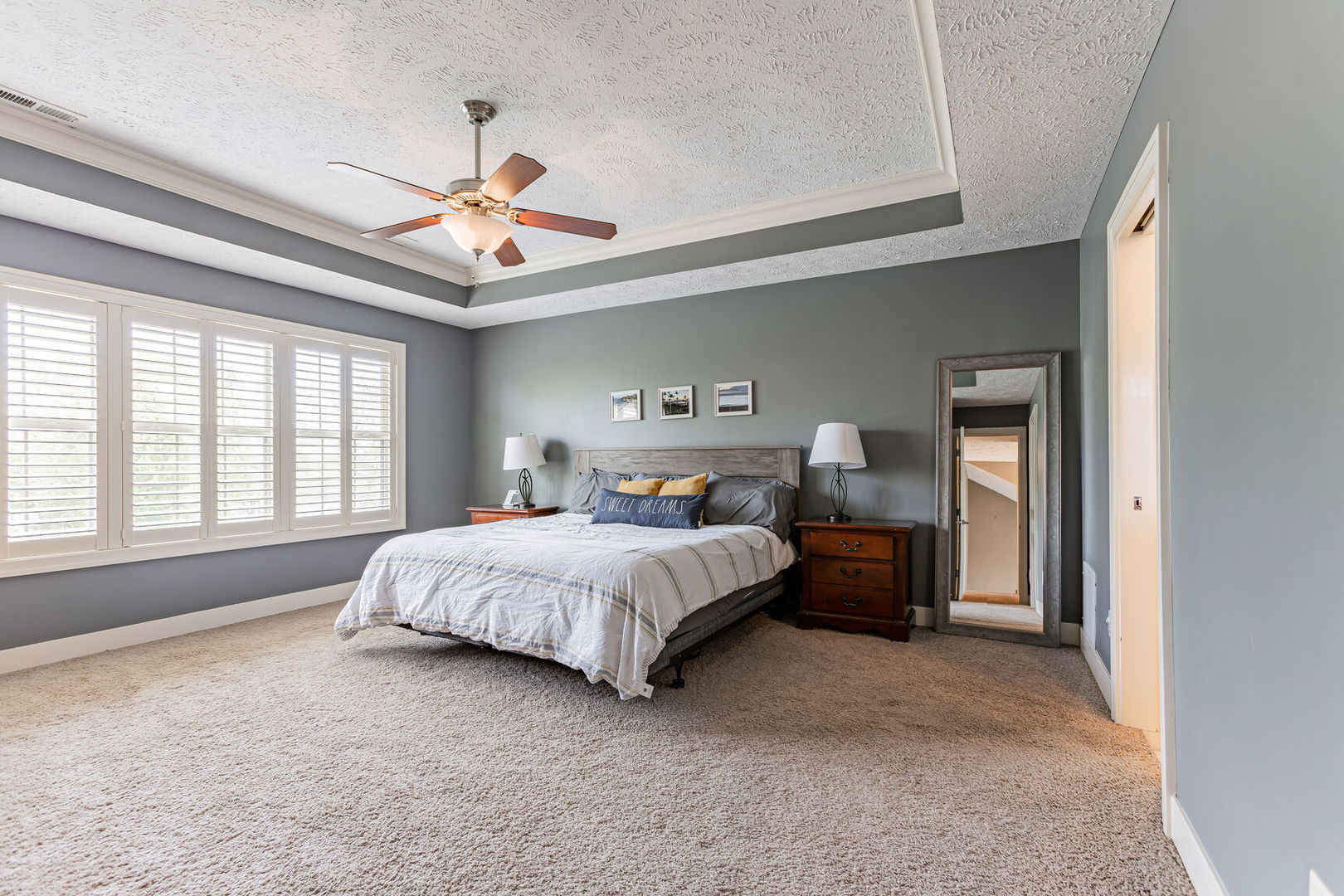 5 Fletcher Court Savoy, IL 61874 - Photo 22 of 48 a spacious bedroom with a bed and a chandelier