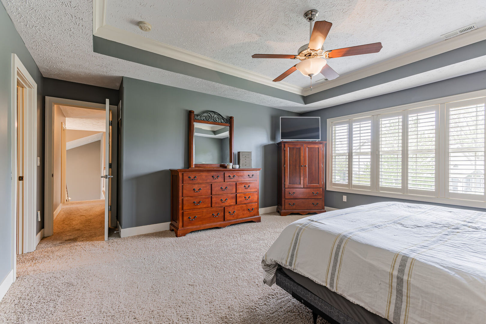 5 Fletcher Court Savoy, IL 61874 - Photo 23 of 48 a spacious bedroom with a bed and a chandelier