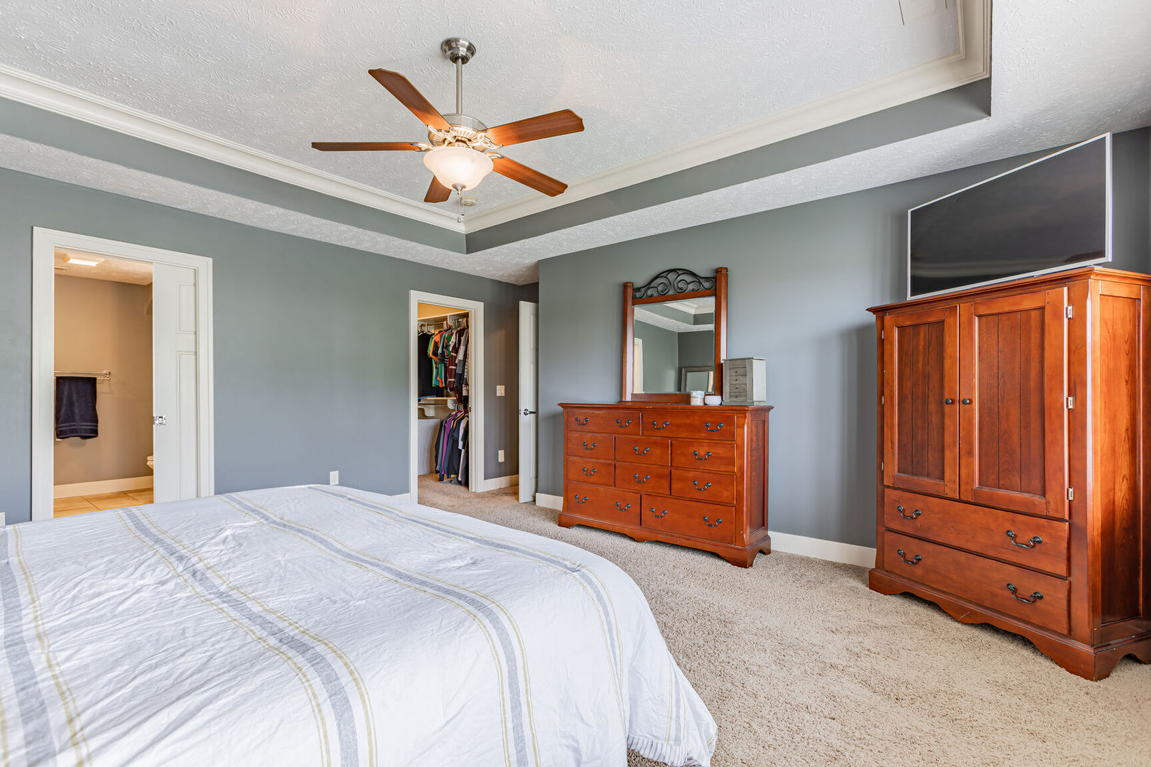 5 Fletcher Court Savoy, IL 61874 - Photo 24 of 48 a bedroom with a bed and a chandelier