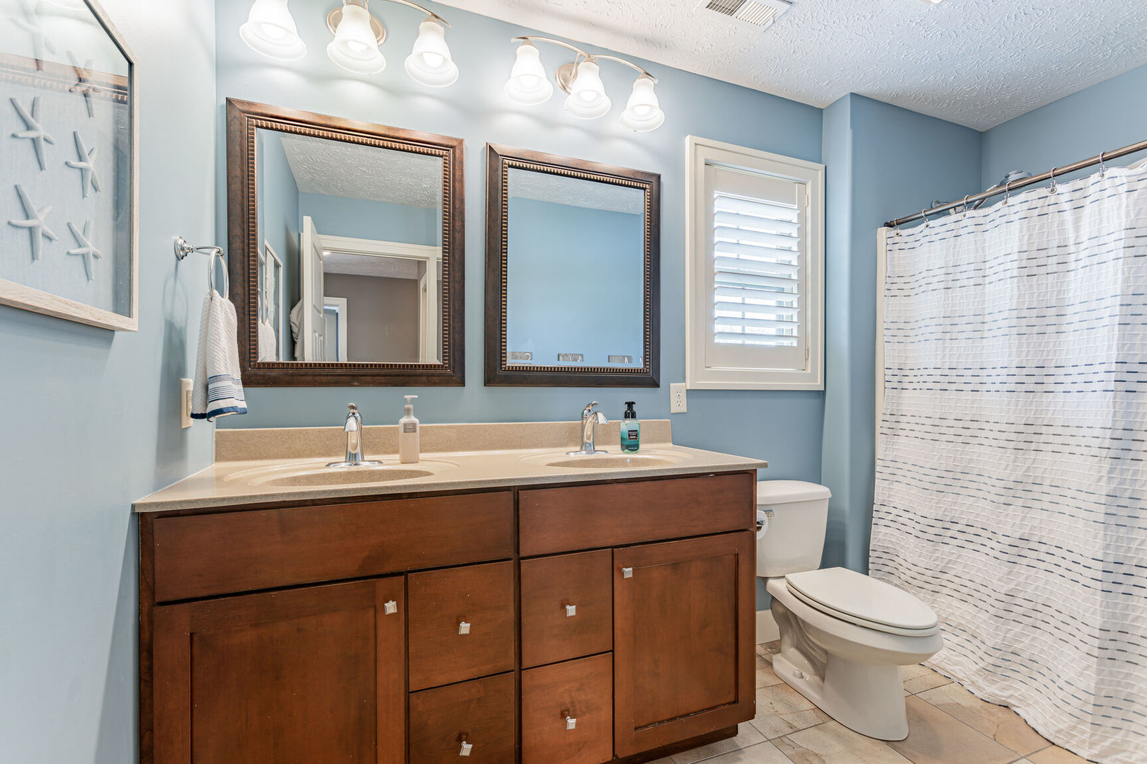 5 Fletcher Court Savoy, IL 61874 - Photo 30 of 48 a bathroom with a toilet a sink a mirror a window and vanity