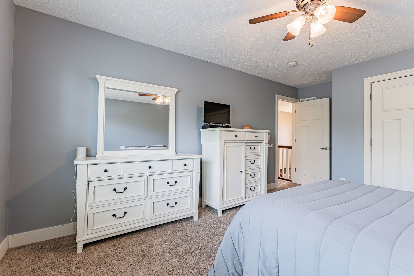 5 Fletcher Court Savoy, IL 61874 - Photo 34 of 48 a bedroom with a bed and a flat tv screen on dresser