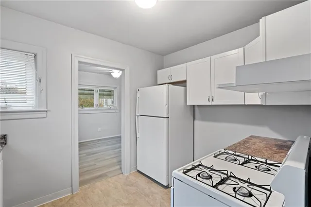 a kitchen with a stove and a refrigerator