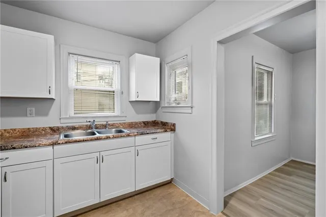 a kitchen with a sink stove and cabinets