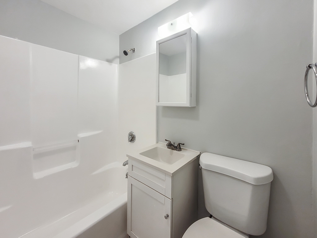 49 Rosedale Street, Unit 1 Boston, MA 02124 - Photo 8 of 8 a bathroom with a toilet sink and mirror