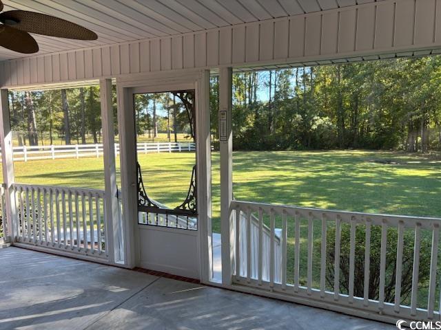 2477 Pleasant Grove Road Loris, SC 29569 - Photo 16 of 25 Doorway to outside featuring a ceiling fan and unfinished concrete floors