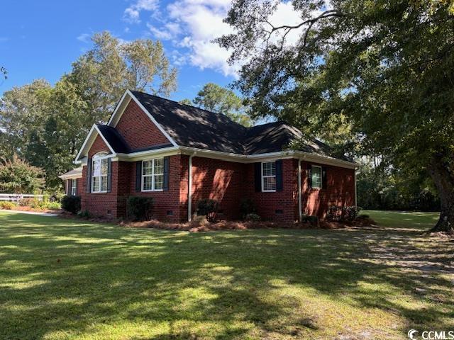 2477 Pleasant Grove Road Loris, SC 29569 - Photo 22 of 25 View of property exterior with crawl space, brick siding, and a lawn