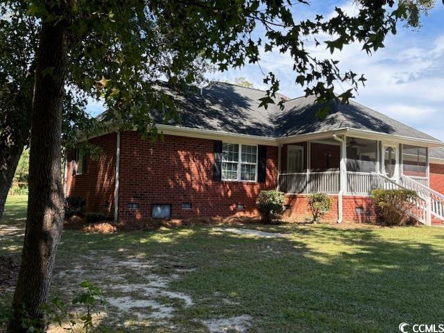 2477 Pleasant Grove Road Loris, SC 29569 - Photo 24 of 25 Rear view of house featuring a yard, brick siding, crawl space, and a sunroom