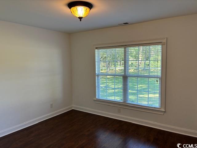 2477 Pleasant Grove Road Loris, SC 29569 - Photo 8 of 25 Spare room featuring baseboards and dark wood-style floors