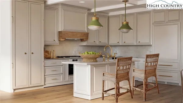 a kitchen with stainless steel appliances granite countertop a white cabinets and stove top oven