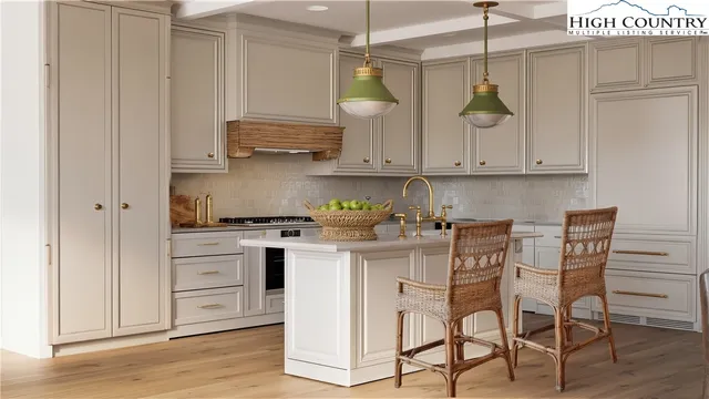 a kitchen with stainless steel appliances granite countertop a white cabinets and stove top oven