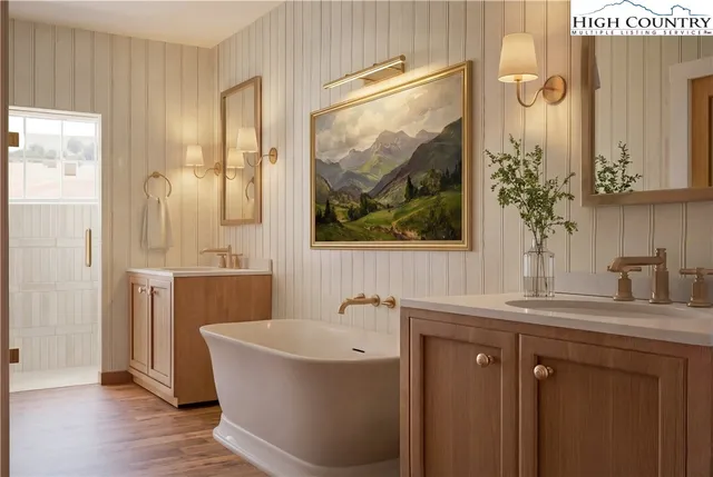 a bathroom with a tub sink and mirror