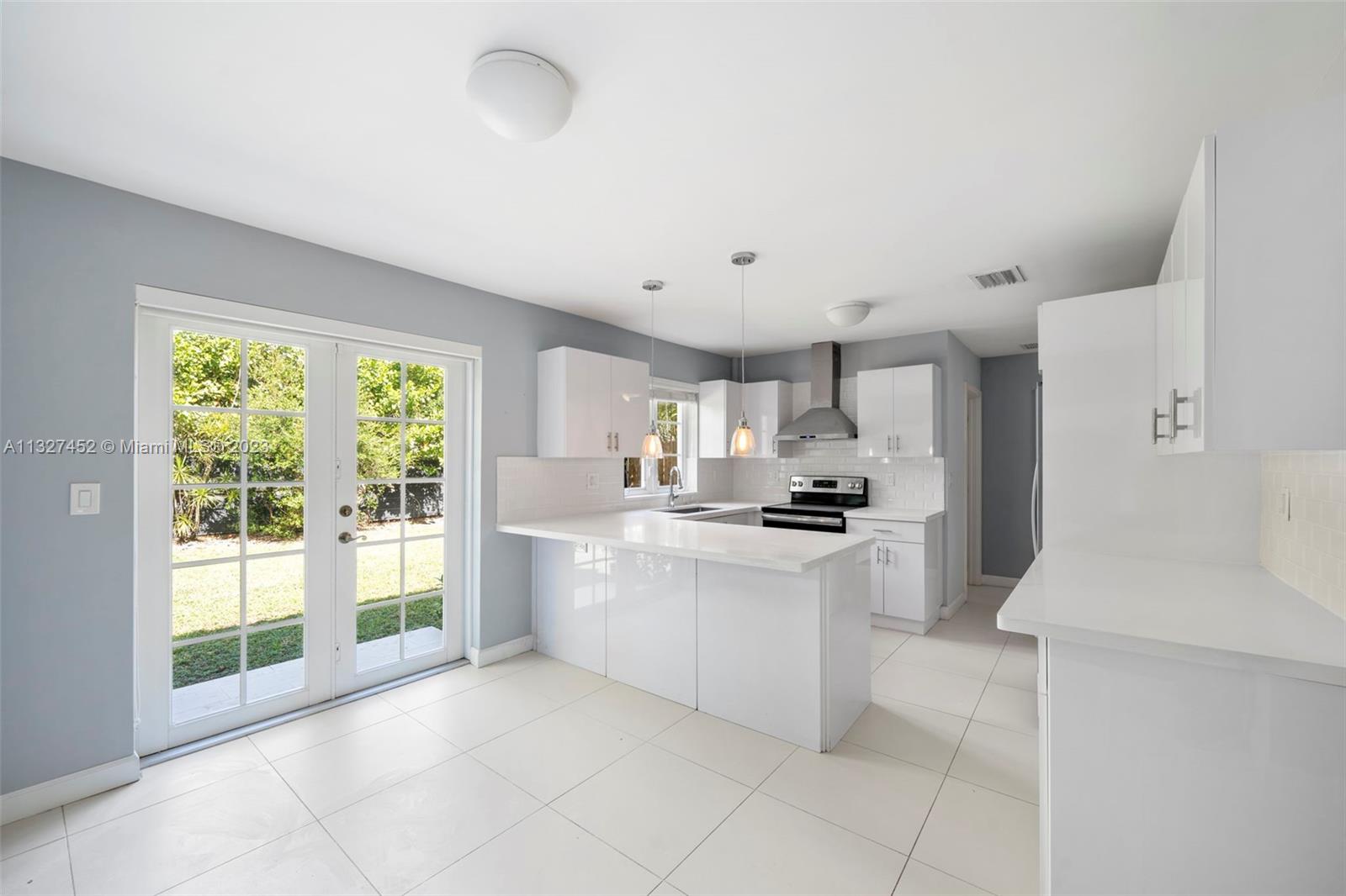 Bayside Miami, FL 33138 - Photo 3 of 9 a large white kitchen with a large window