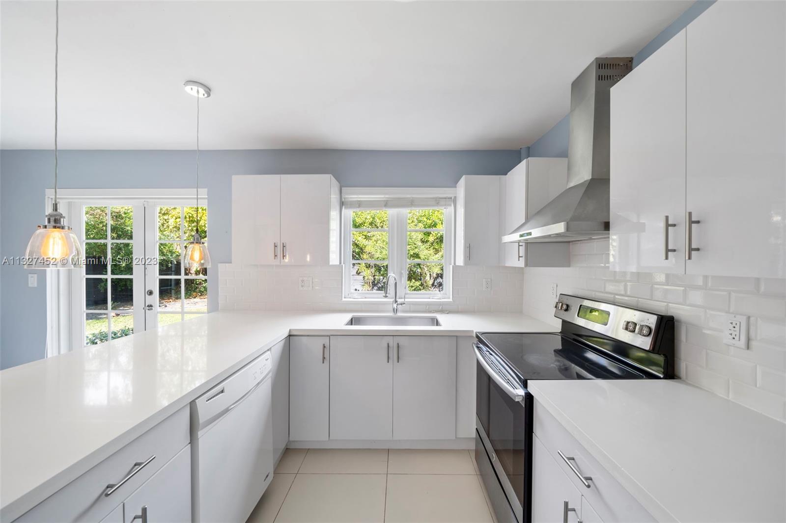 Bayside Miami, FL 33138 - Photo 8 of 9 a kitchen with a sink stove and cabinets
