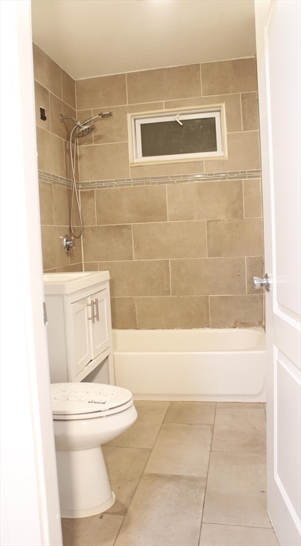 45-47 Coolidge Road, Unit 2 Boston, MA 02134 - Photo 6 of 11 a bathroom with a toilet a sink and bathtub