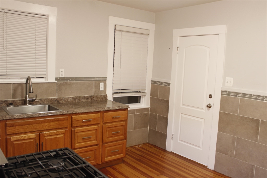 45-47 Coolidge Road, Unit 2 Boston, MA 02134 - Photo 8 of 11 a kitchen with stainless steel appliances a stove and a refrigerator
