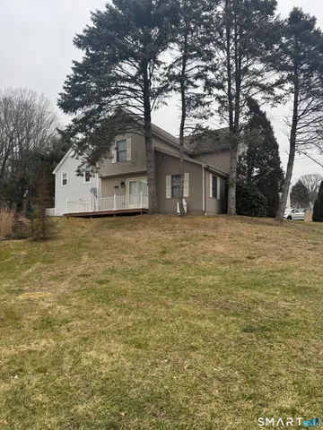 a house that has a tree in front of it