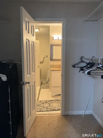 a view of a hallway with a door and wooden floor