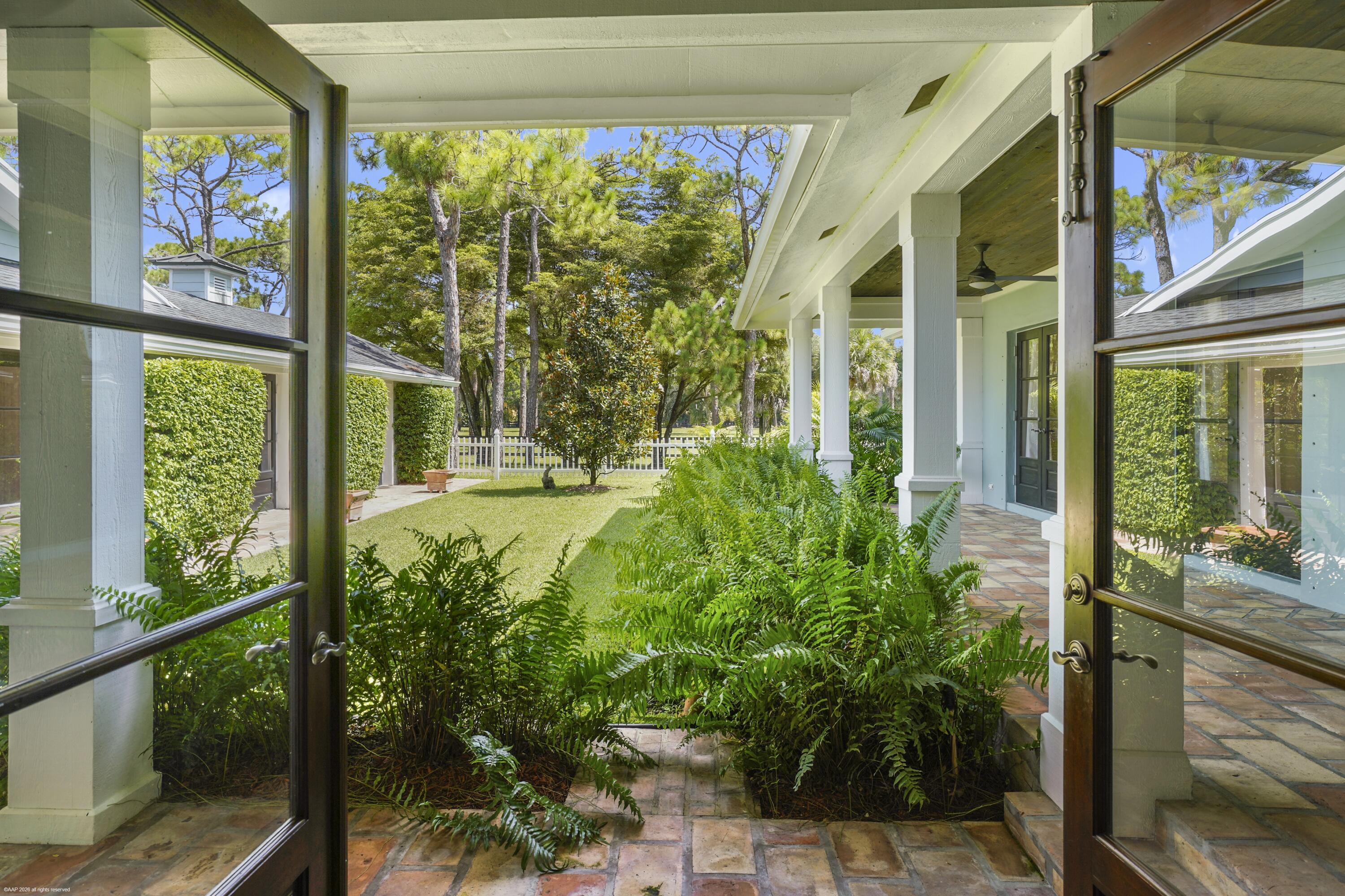 2740 Buck Ridge Trail Loxahatchee, FL 33470 - Photo 22 of 70 View from Dining room to Loggia