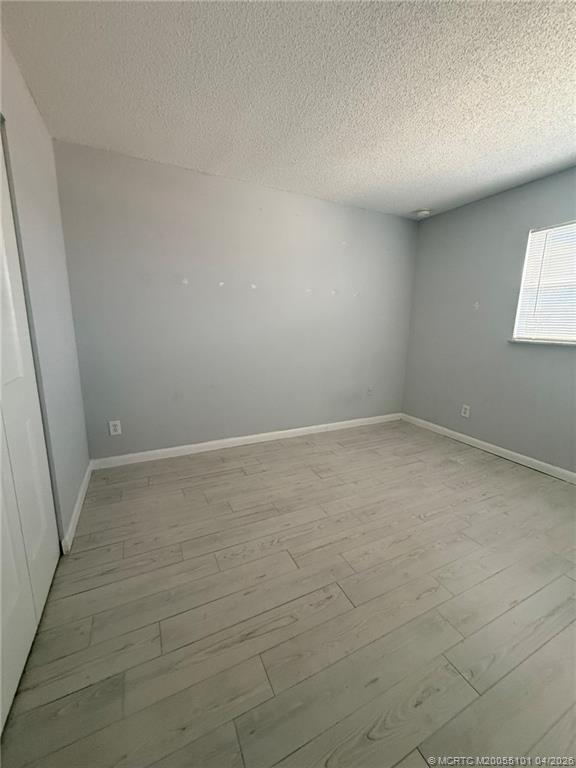 2124 Southeast Edler Drive Stuart, FL 34994 - Photo 11 of 16 wooden floor in an empty room with a window
