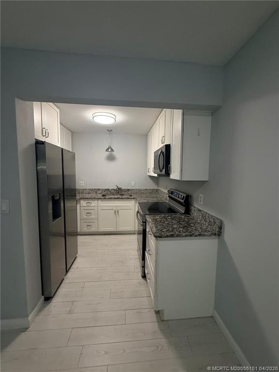 2124 Southeast Edler Drive Stuart, FL 34994 - Photo 5 of 16 a kitchen with stainless steel appliances granite countertop a sink stove and refrigerator