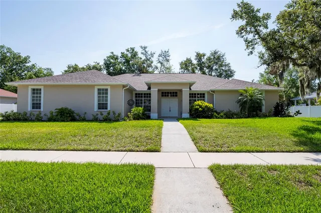 a front view of house with yard and green space