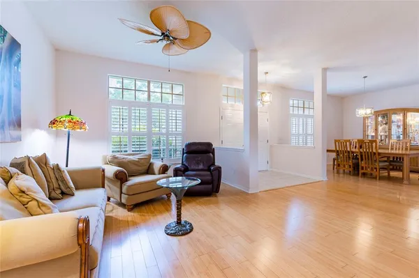 a view of a livingroom with bookshelf and a window