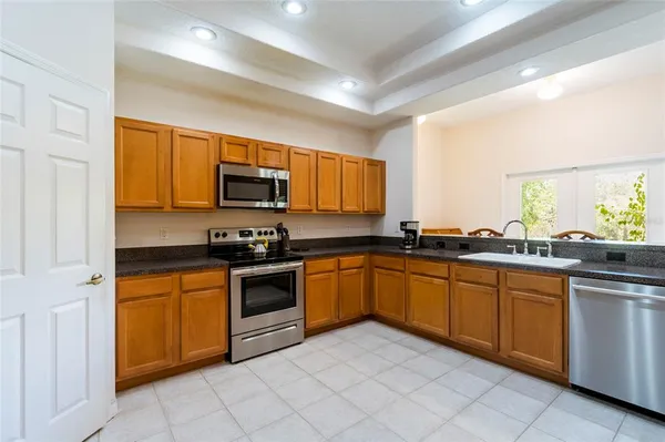 a kitchen with stainless steel appliances granite countertop a sink and stove top oven