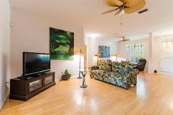 a bedroom with a bed a chandelier and a window
