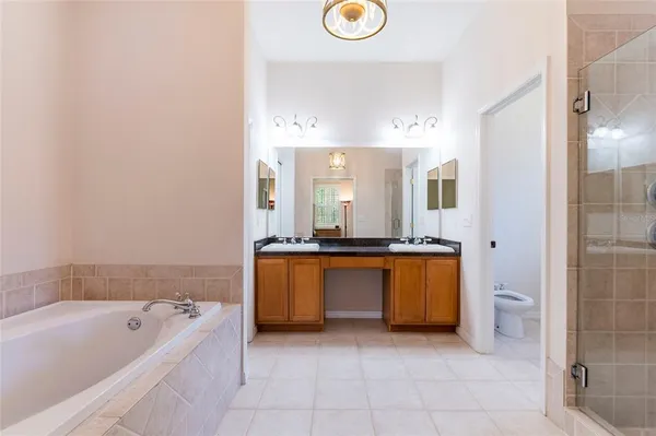 a spacious bathroom with a bathtub and mirror