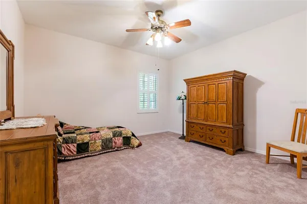 a room with a bed and a dresser