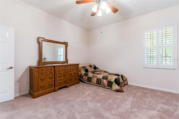 a bed sitting in a bedroom next to a window
