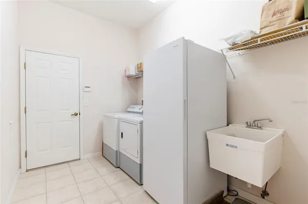 a view of a patio with table and chairs and potted plants