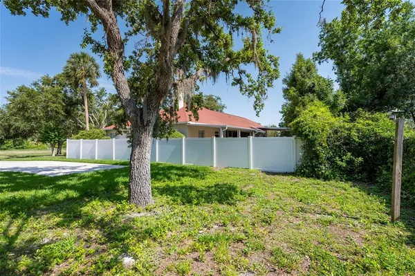 a view of house with swimming pool and green space
